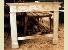 Mantlepiece with classical design, hand carved in pine then painted to resemble marble